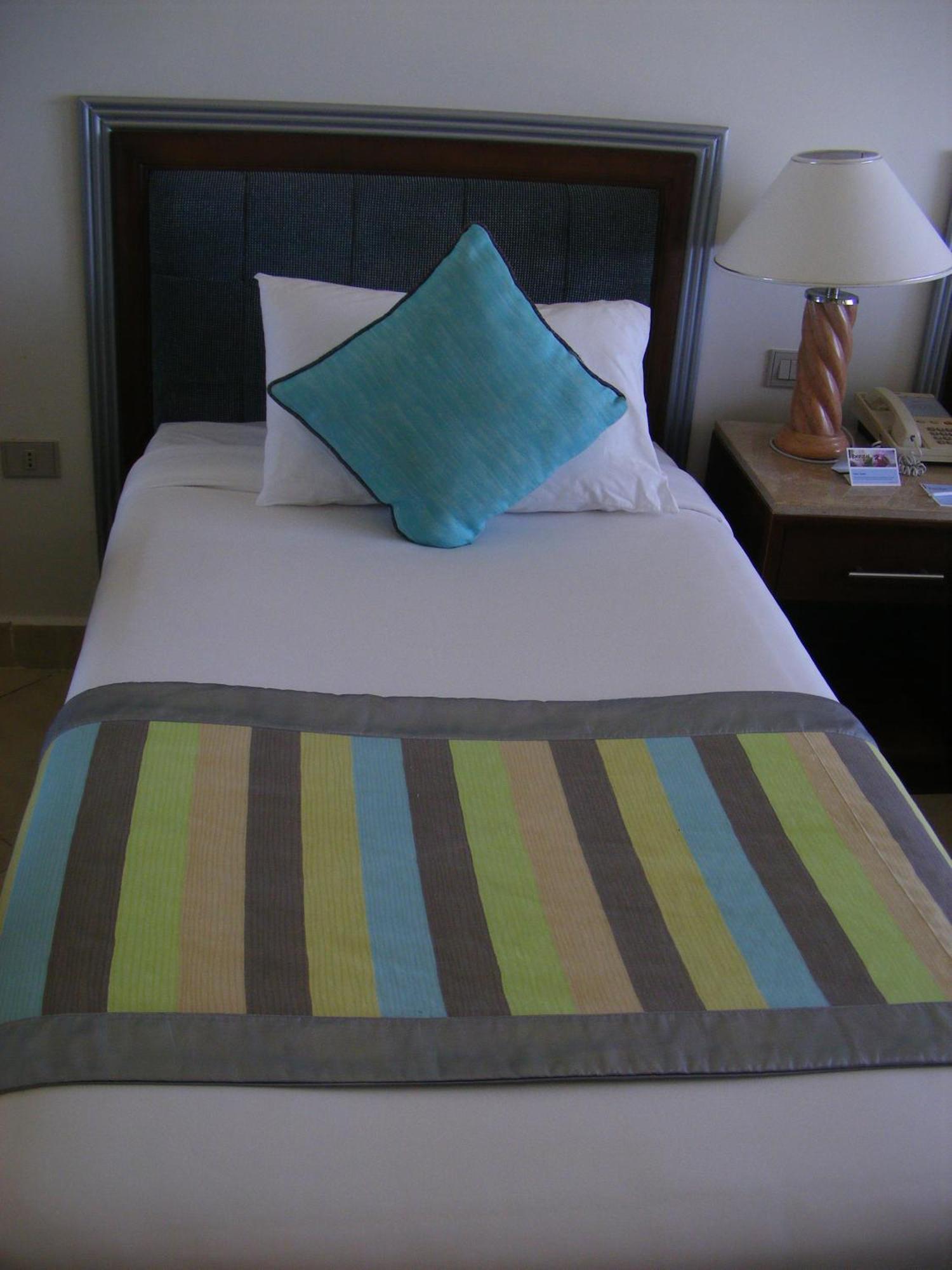 Borg El Arab Beach Resort Exterior photo A bed with a bed runner