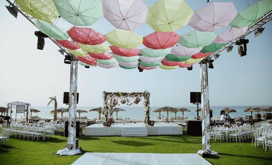 Borg El Arab Beach Resort Exterior photo A canopy of umbrellas